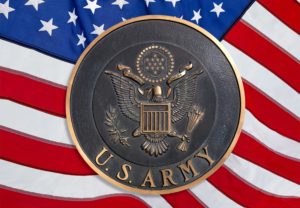 army challenge coin with the background of the us american flag